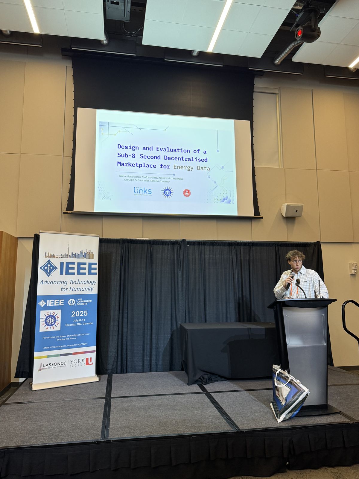 On stage during a paper presentation at COMPSAC 2025 Toronto