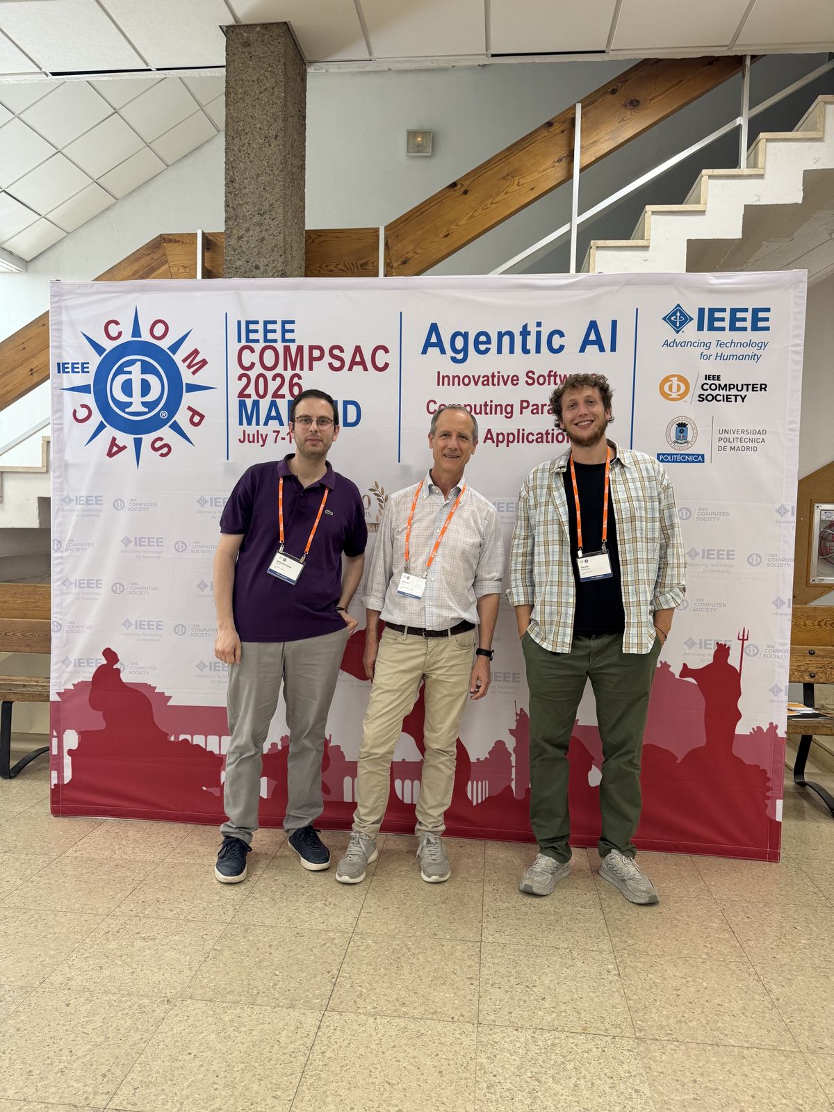 Group photo in front of the IEEE COMPSAC 2026 Madrid banner