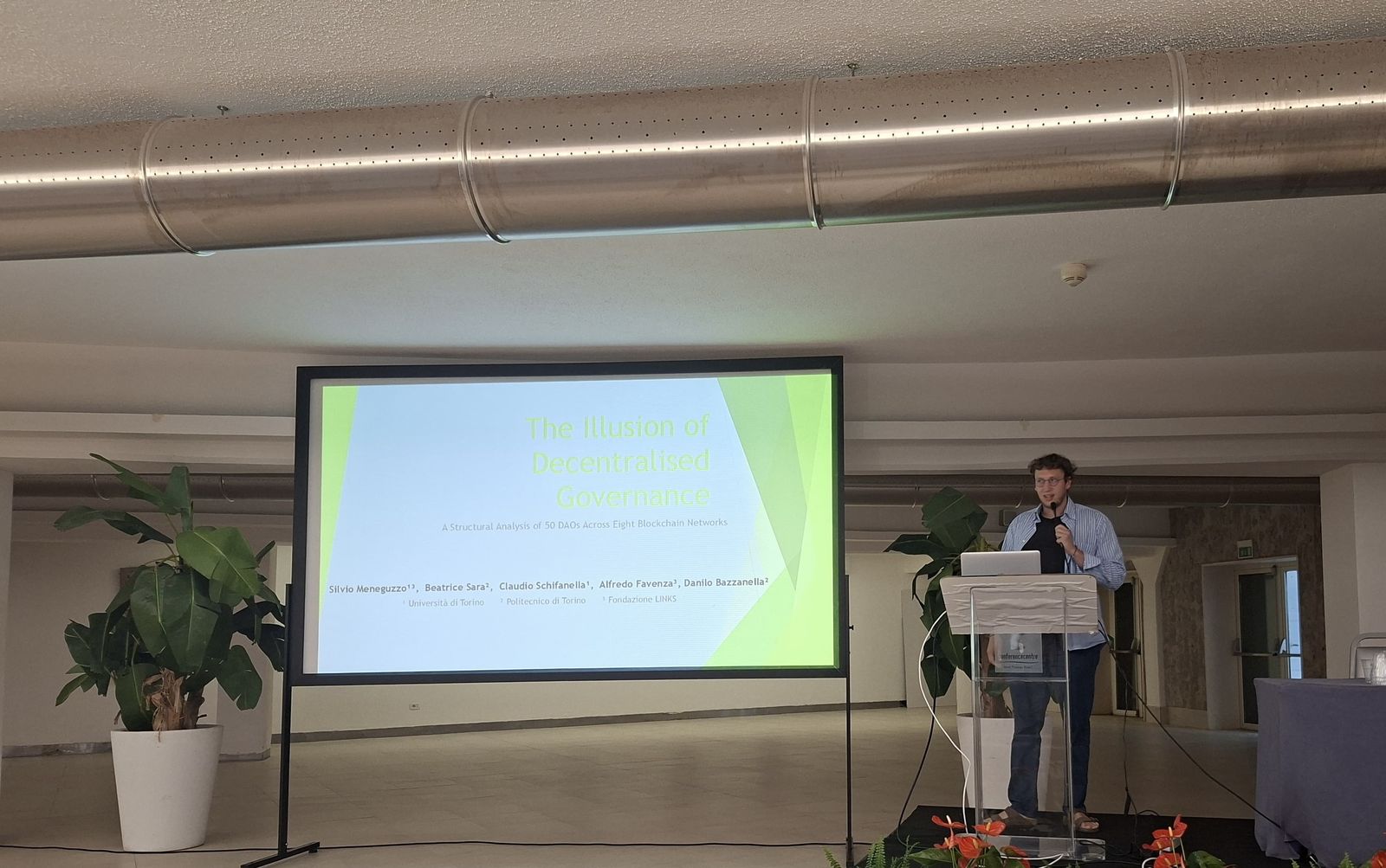 Silvio Meneguzzo presenting The Illusion of Decentralised Governance at DLT2026 in Pula
